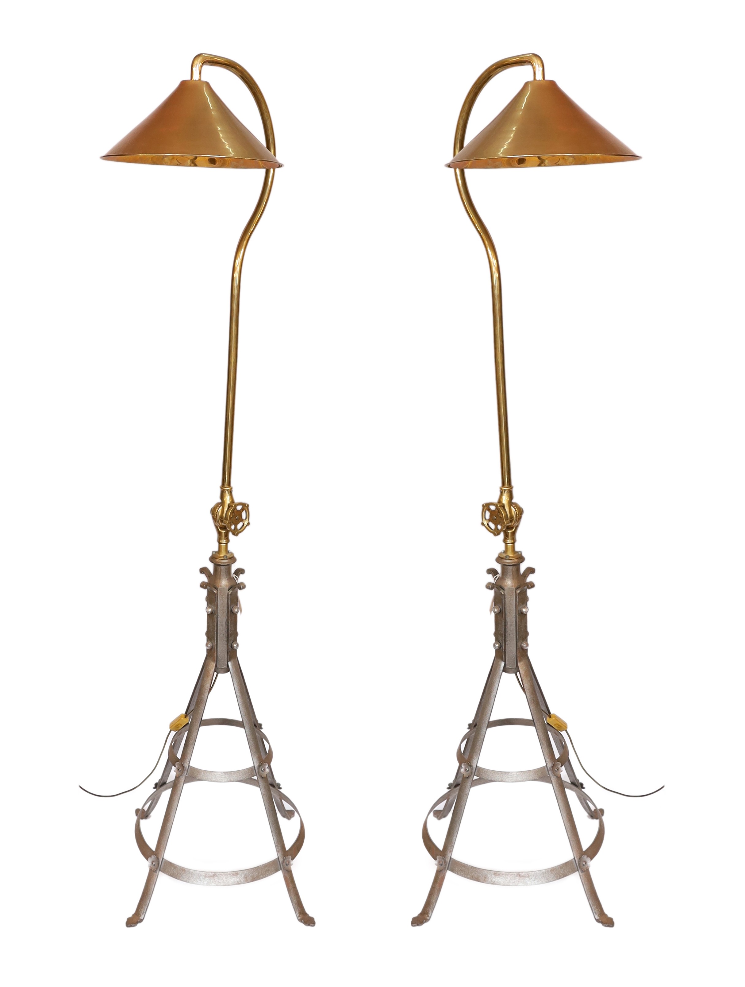 A pair of industrial style brass and wrought iron adjustable lamp standards, height 194cm. width of base 62cm